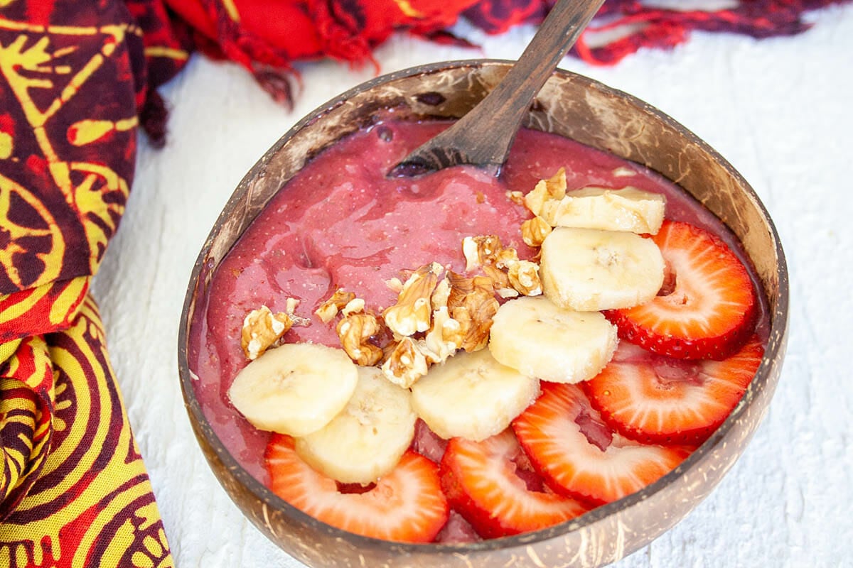 Strawberry Beet Smoothie Bowl in a bowl with spoon.