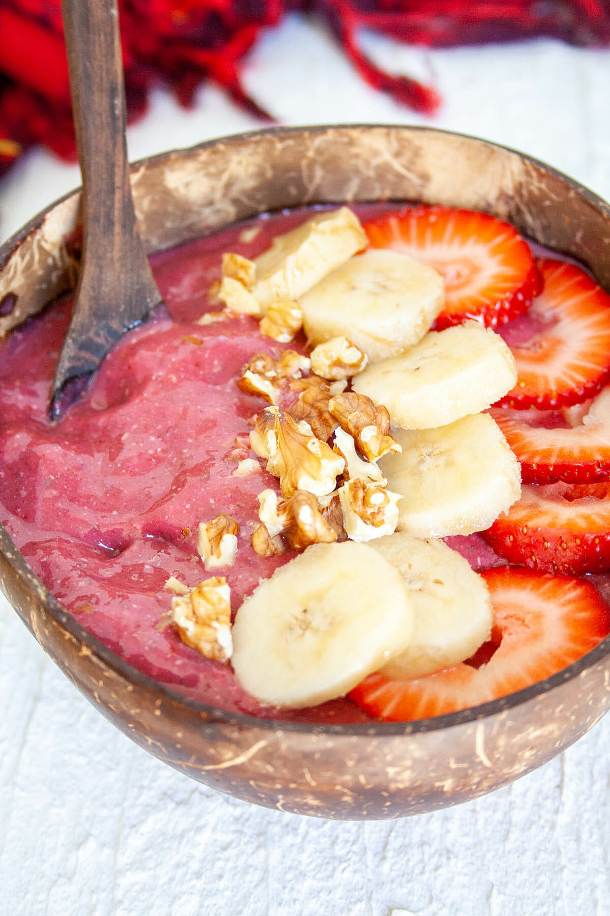 Strawberry Beet Smoothie Bowl with spoon close up.