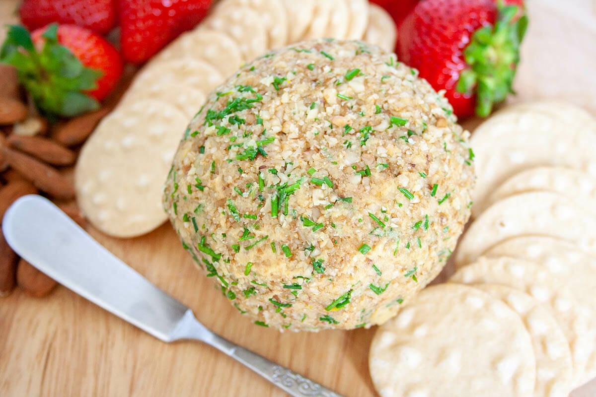 Vegan Cheese Ball with crackers and strawberries.