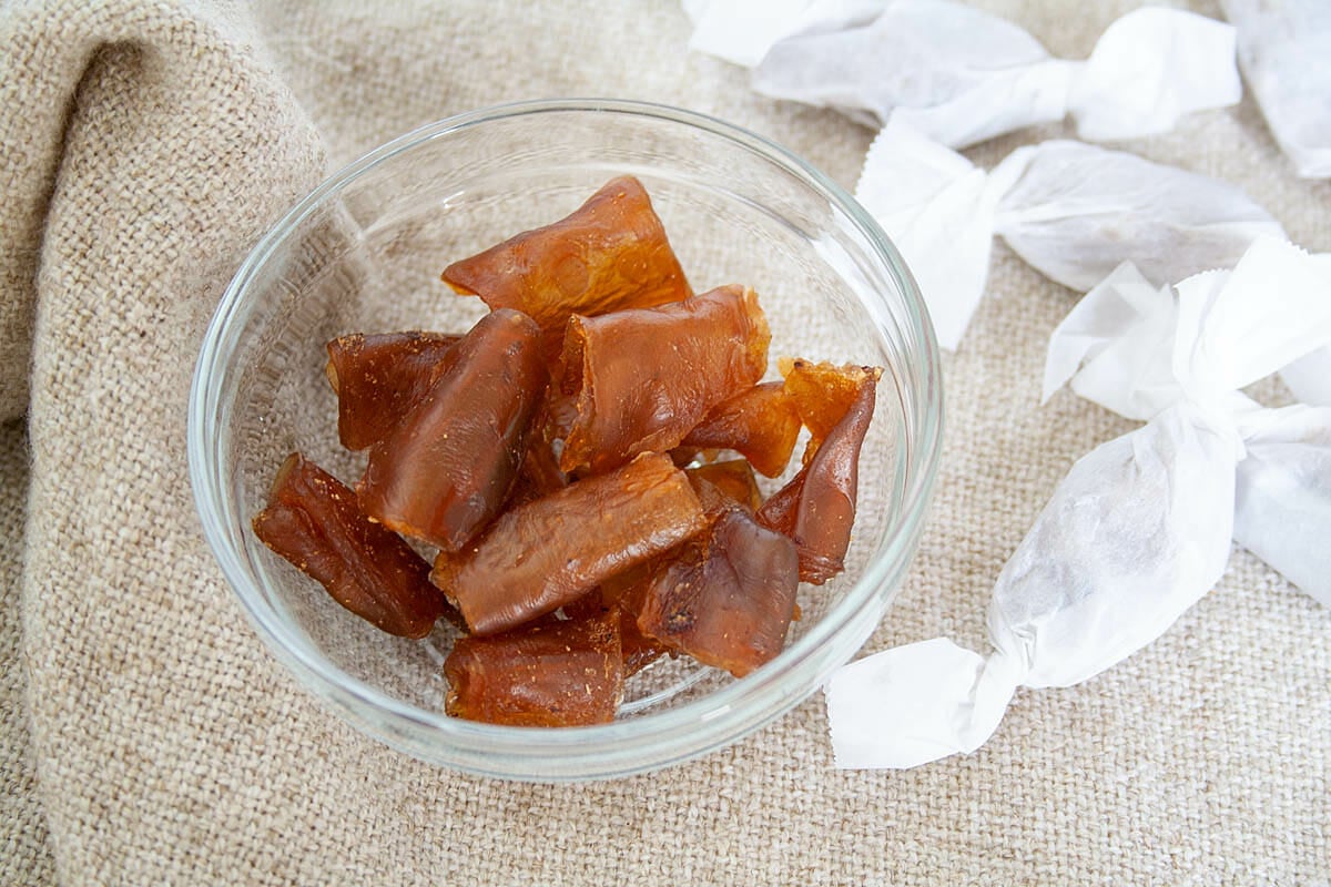Ginger Kombucha Scoby Candy in a dish and more that are wrapped in the background.