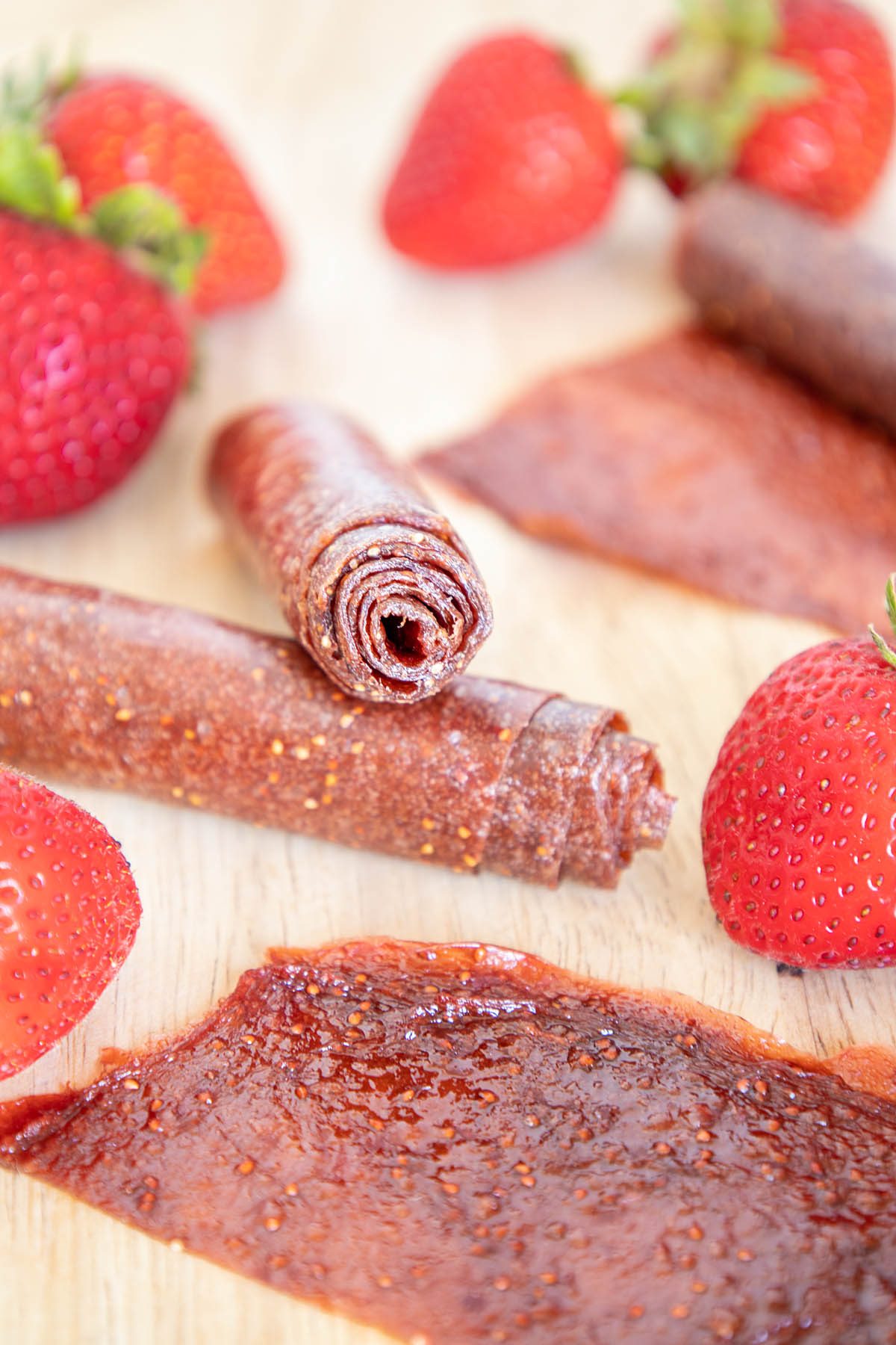 Kombucha Scoby Strawberry Fruit Roll-Ups on a cutting board.