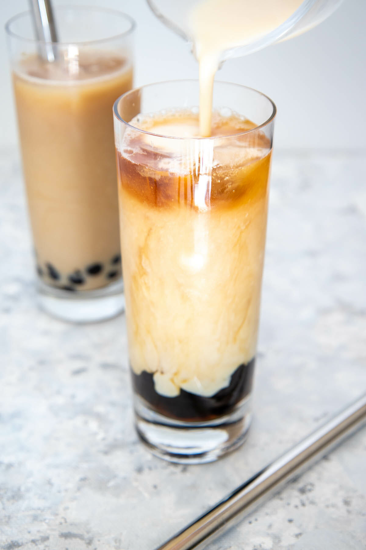 Soy milk being poured into glass with Vegan Boba Tea.