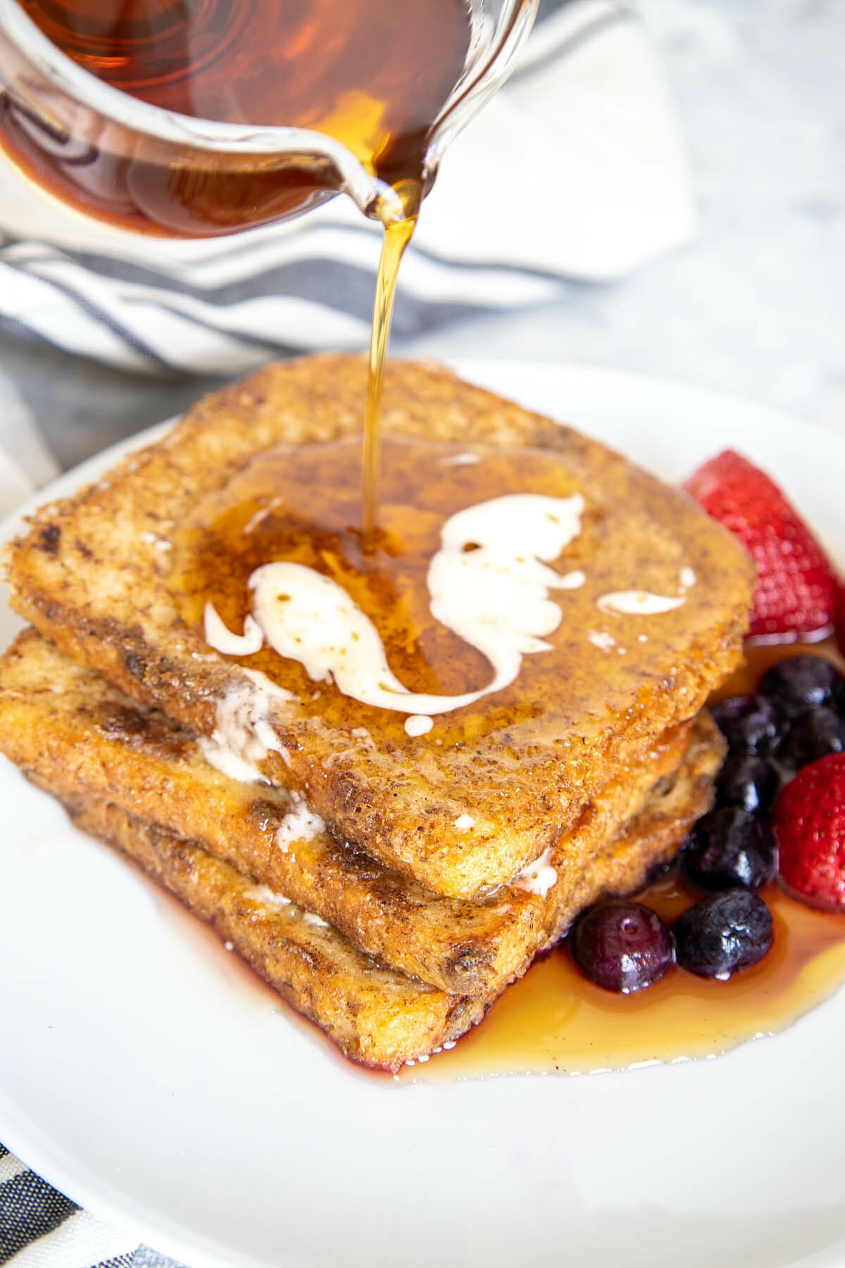 Maple syrup being poured on Vegan French Toast.