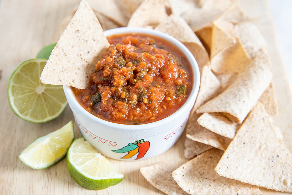 Restaurant Style Salsa with limes and tortilla chips.