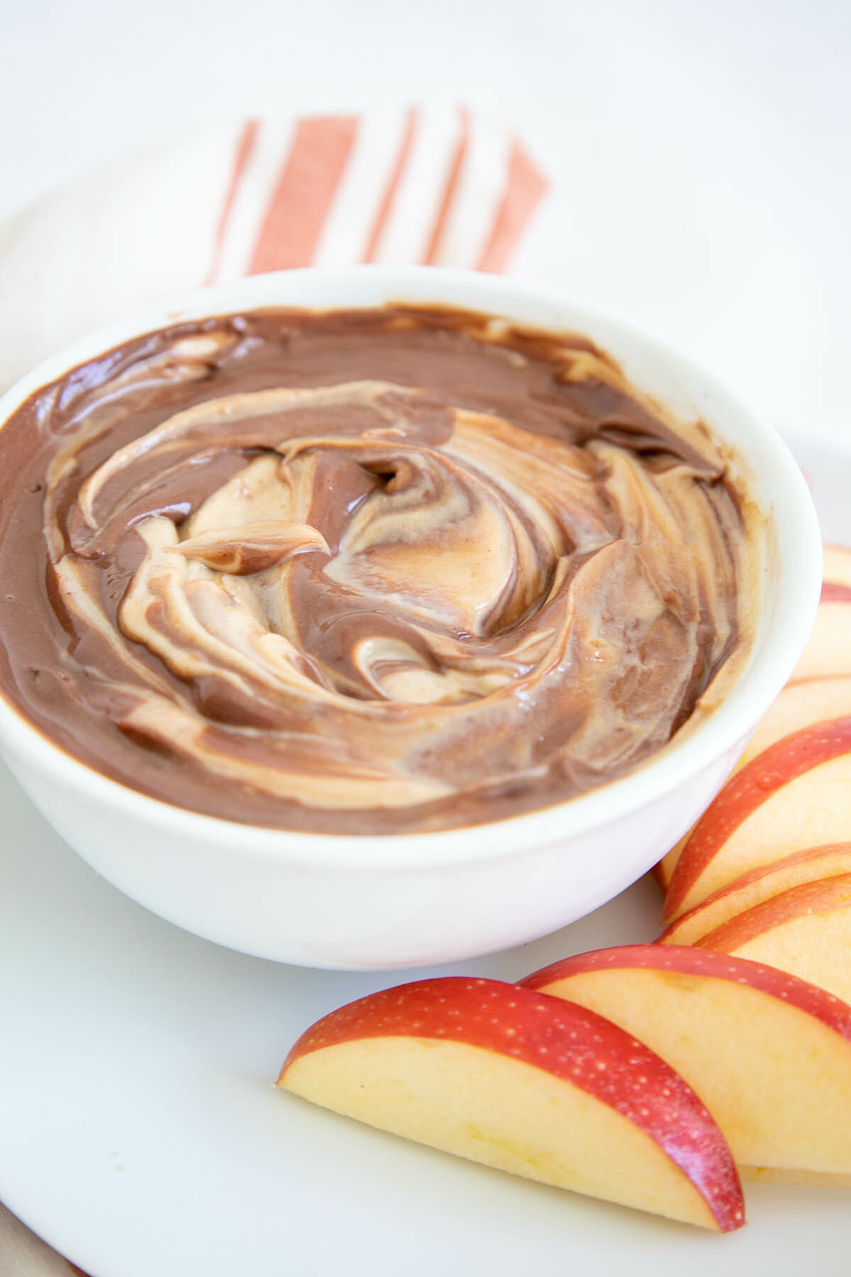 Chocolate Peanut Butter Dip in a bowl with apple slices.