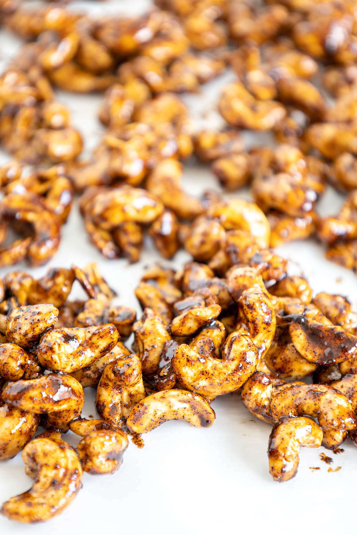 Maple Chipotle Cashews on parchment paper.