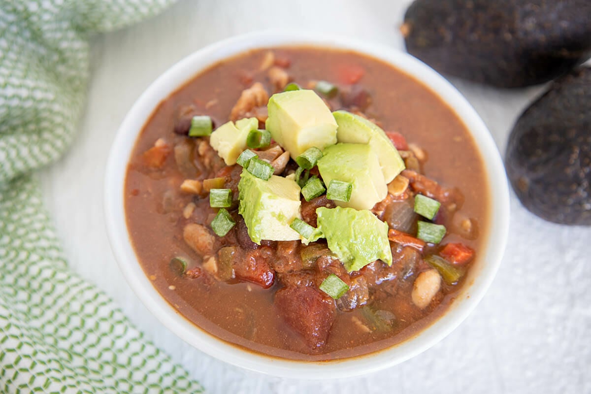 Slow Cooker Tempeh Chili in a bowl with avocados.