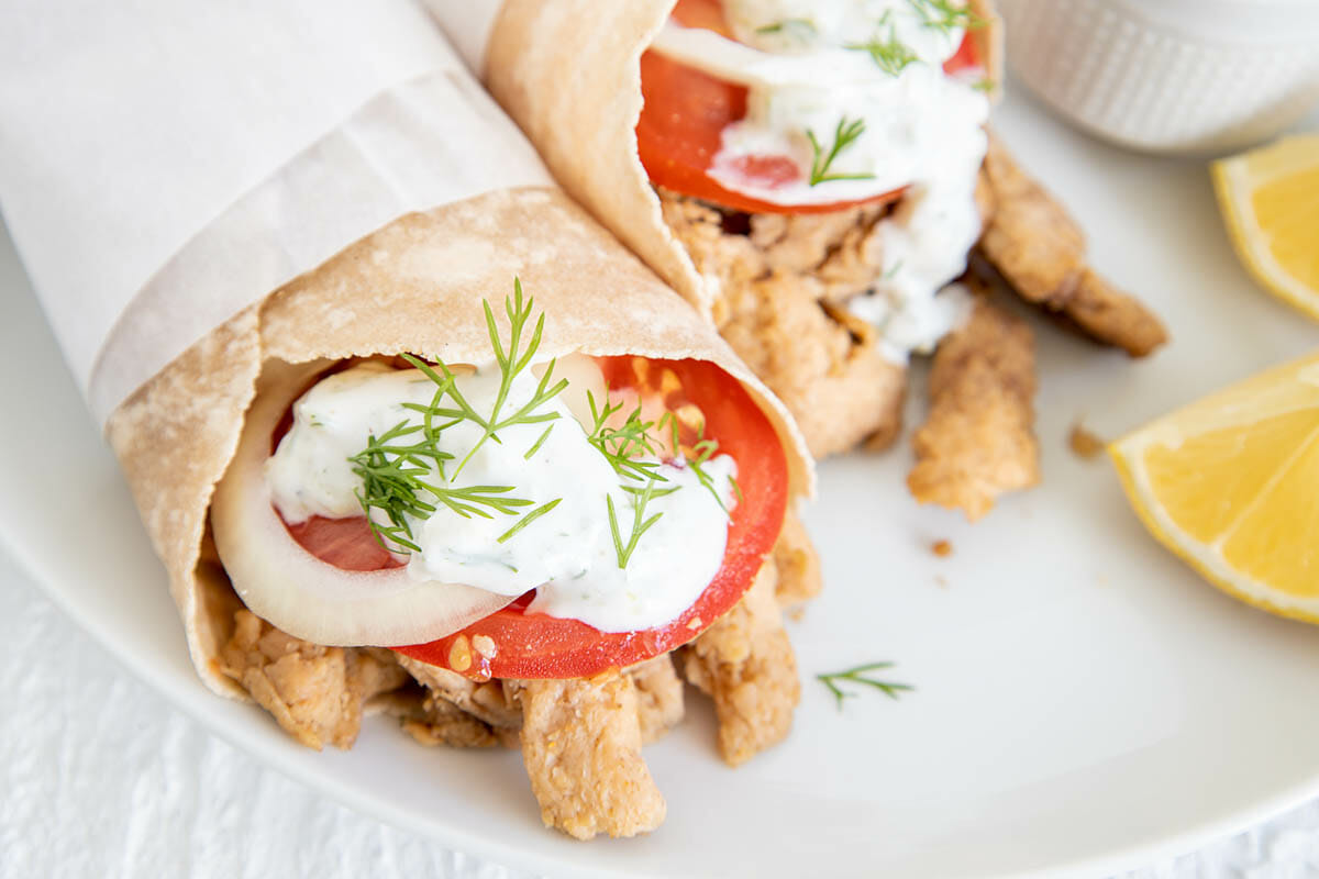 Vegan Gyros on a plate with lemon wedges.