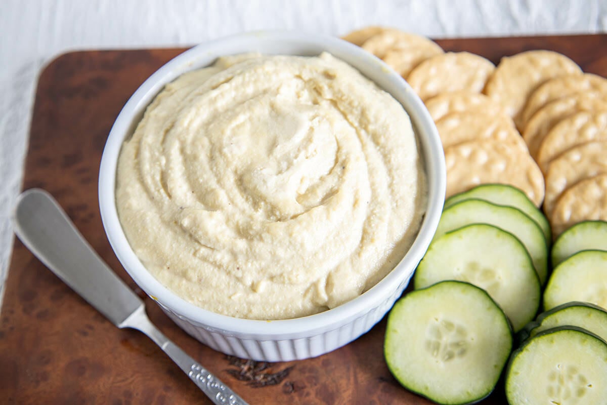 Vegan Cream Cheese with crackers and sliced cucumber.