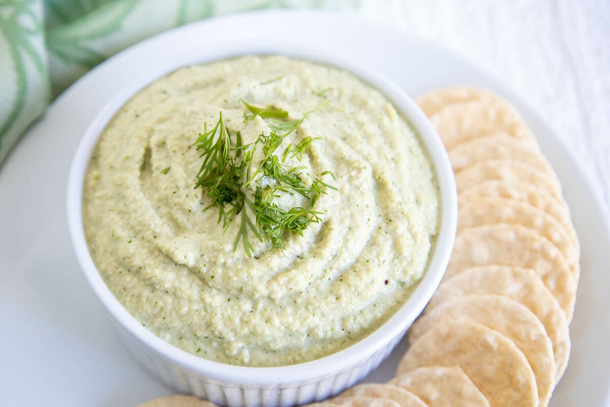 Vegan Dill Dip on a plate with crackers.