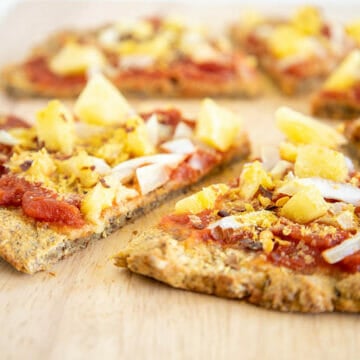 Vegan Cauliflower Pizza Crust on cutting board.