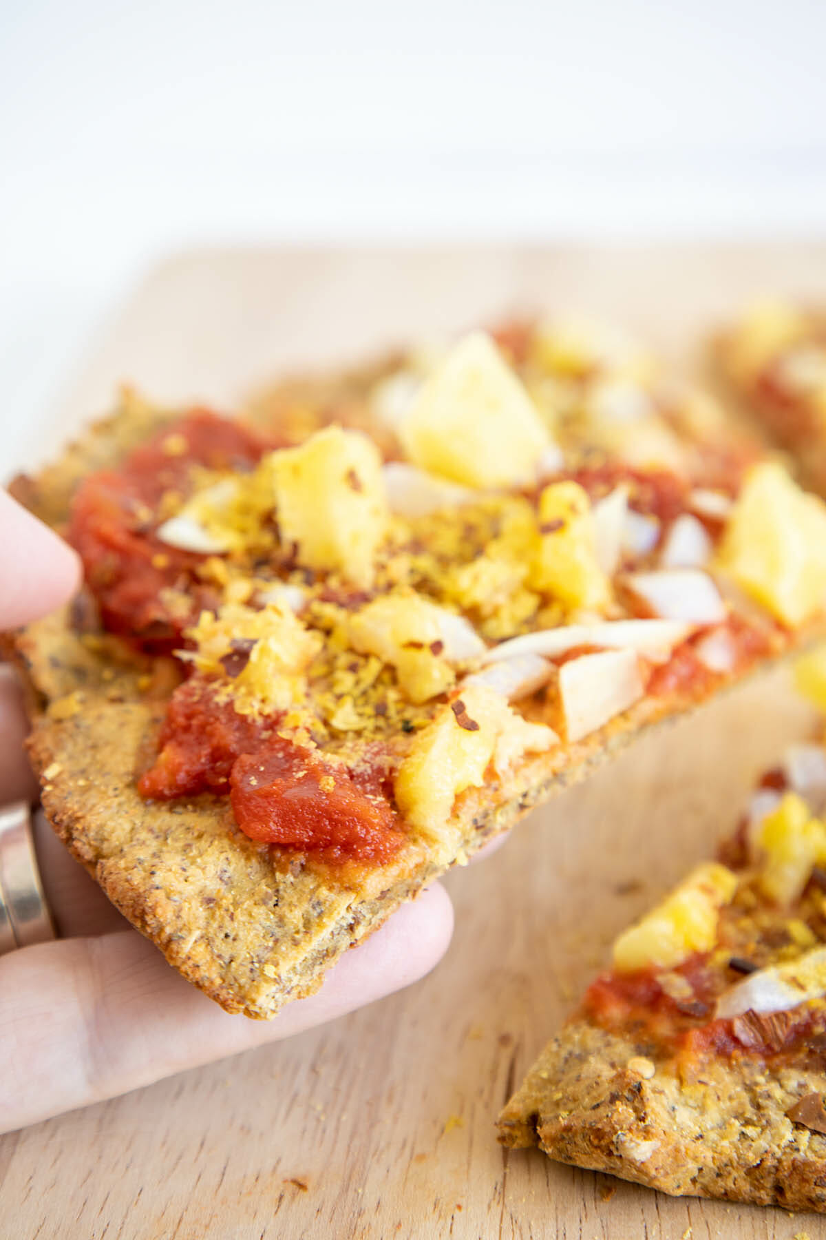 Vegan Cauliflower Pizza Crust in hand.