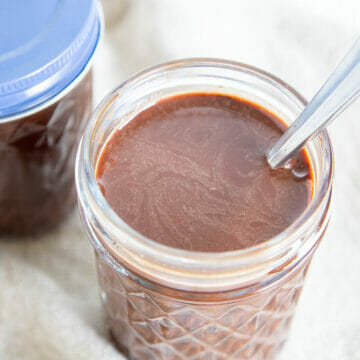 Chocolate Simple Syrup in two mason jars.