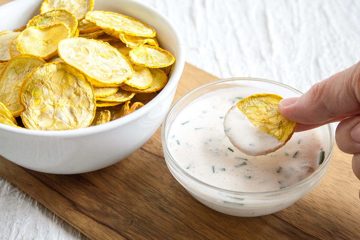 Salt and Vinegar Dehydrated Squash Chip in hand.