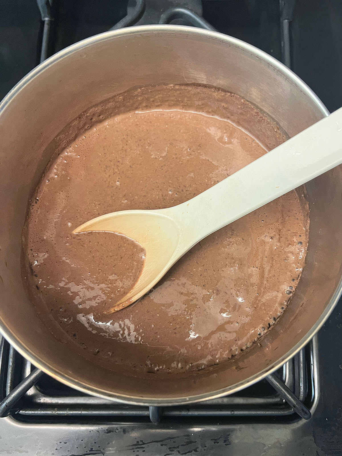 Ingredients in a saucepan with spoon.