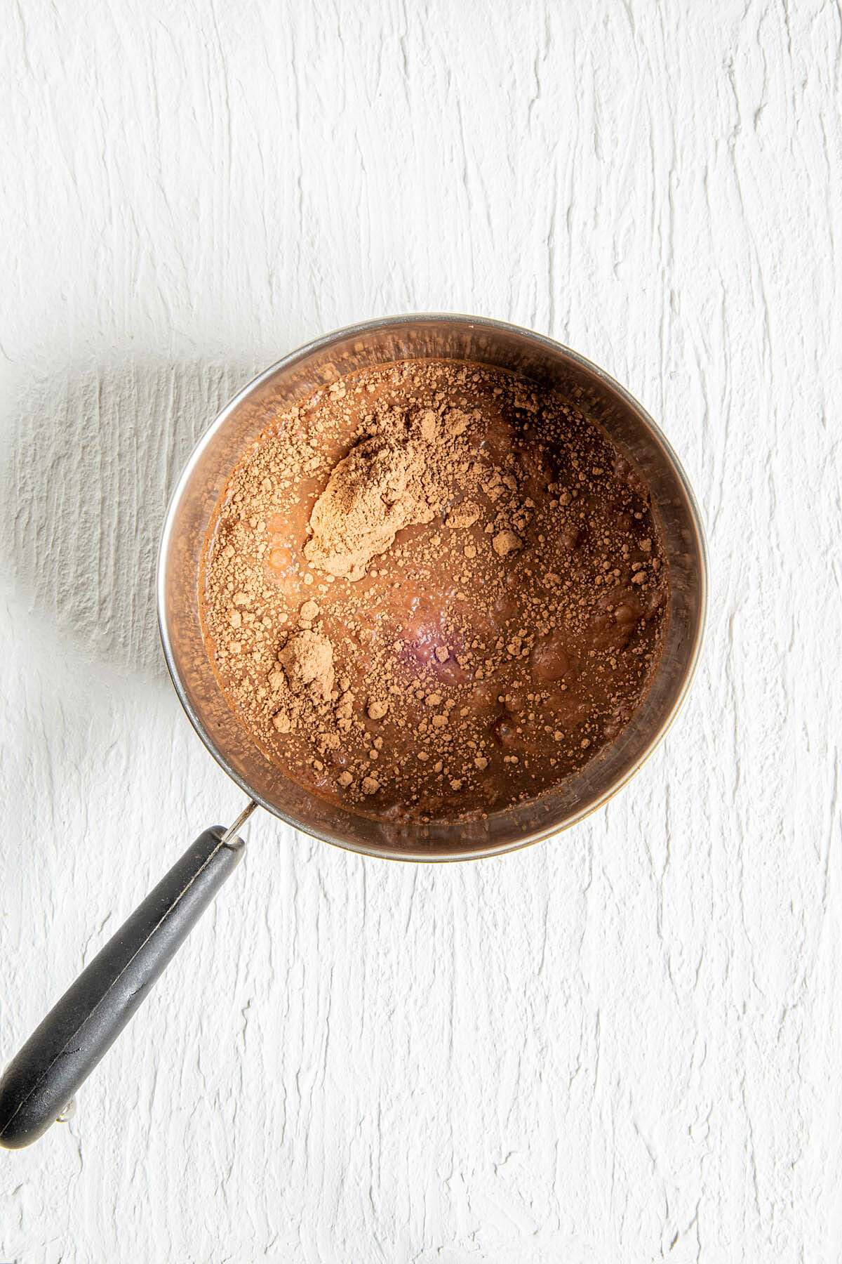 Cacao powder, brown sugar, and water in a saucepan.