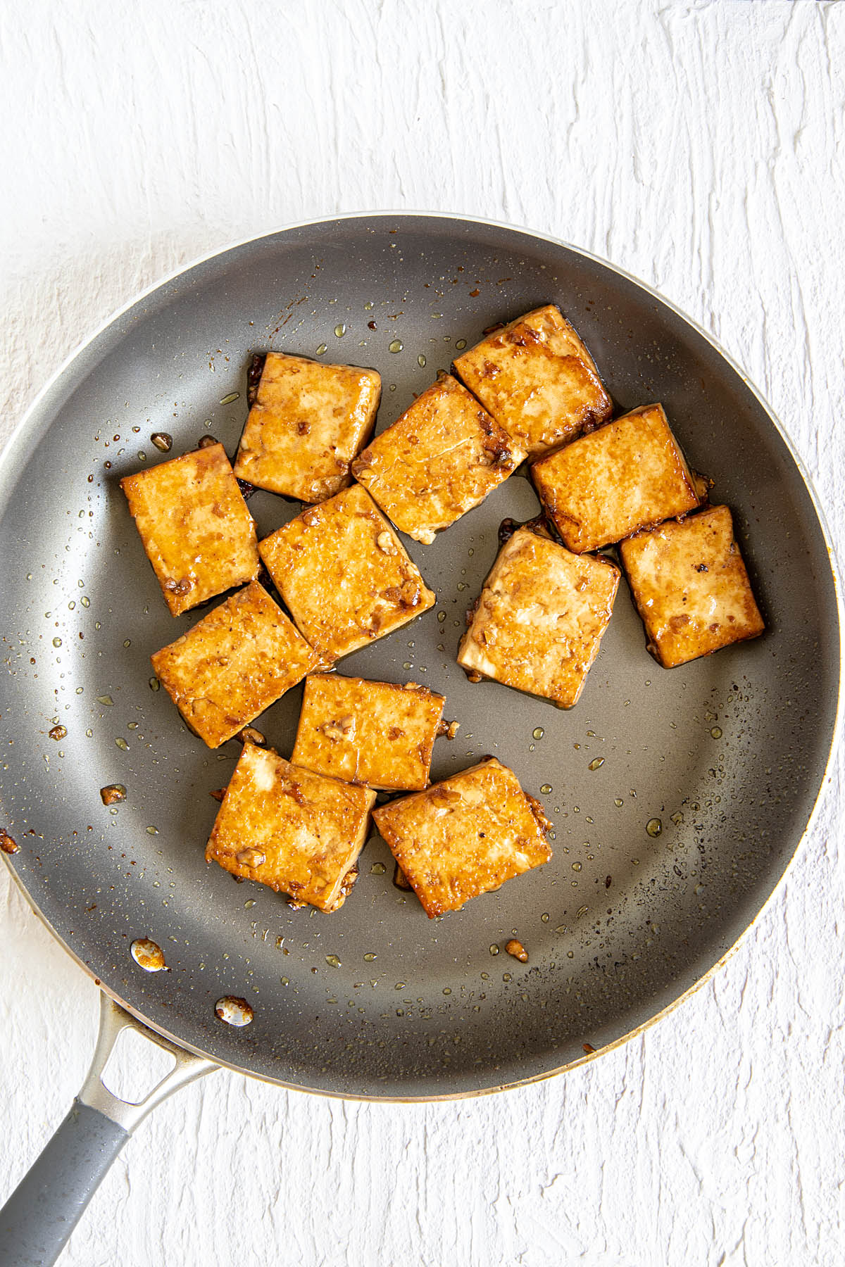 Marinated and cooked tofu in a skillet.