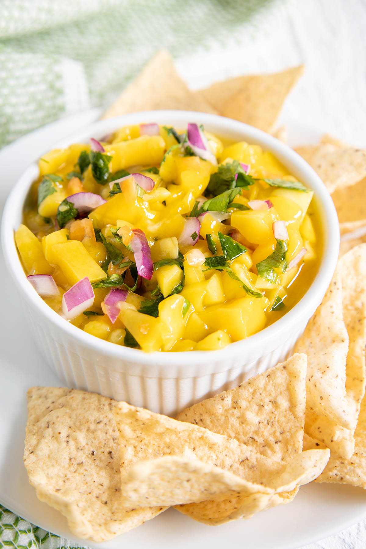 Best Mango Habanero Salsa with tortilla chips on a plate.