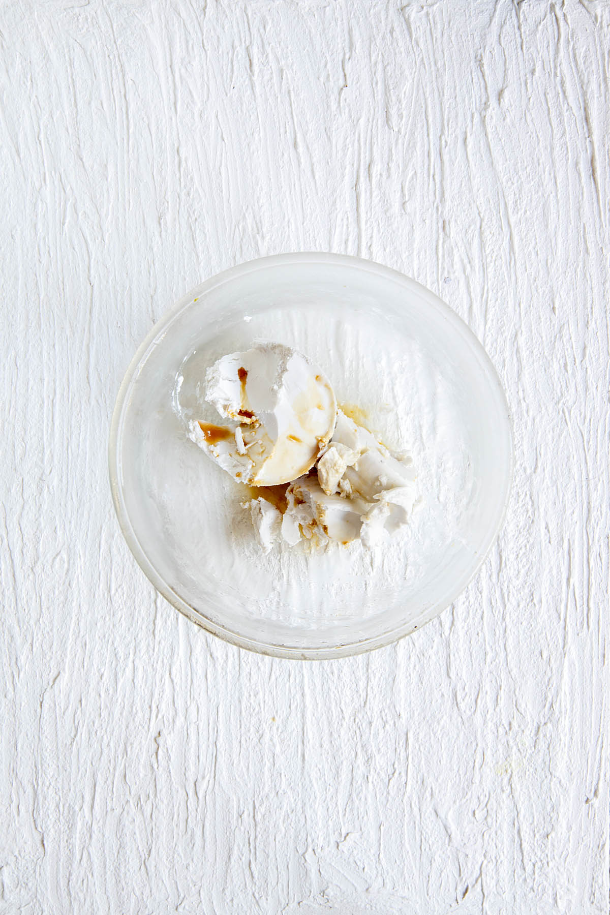 Coconut cream and vanilla extract in a bowl.