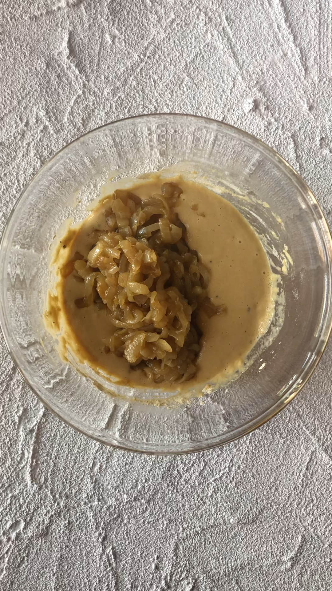 Caramelized onions and batter in a bowl.