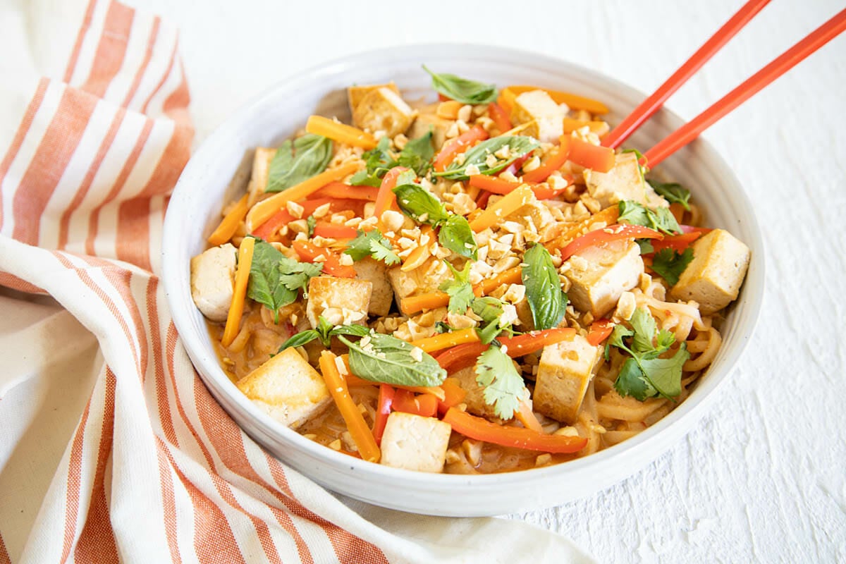 Tofu Peanut Noodles in a bowl with napkin.