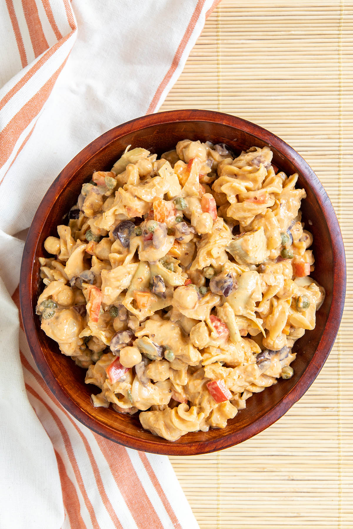 Red Lentil Pasta Salad with Chickpeas in a wood bowl.