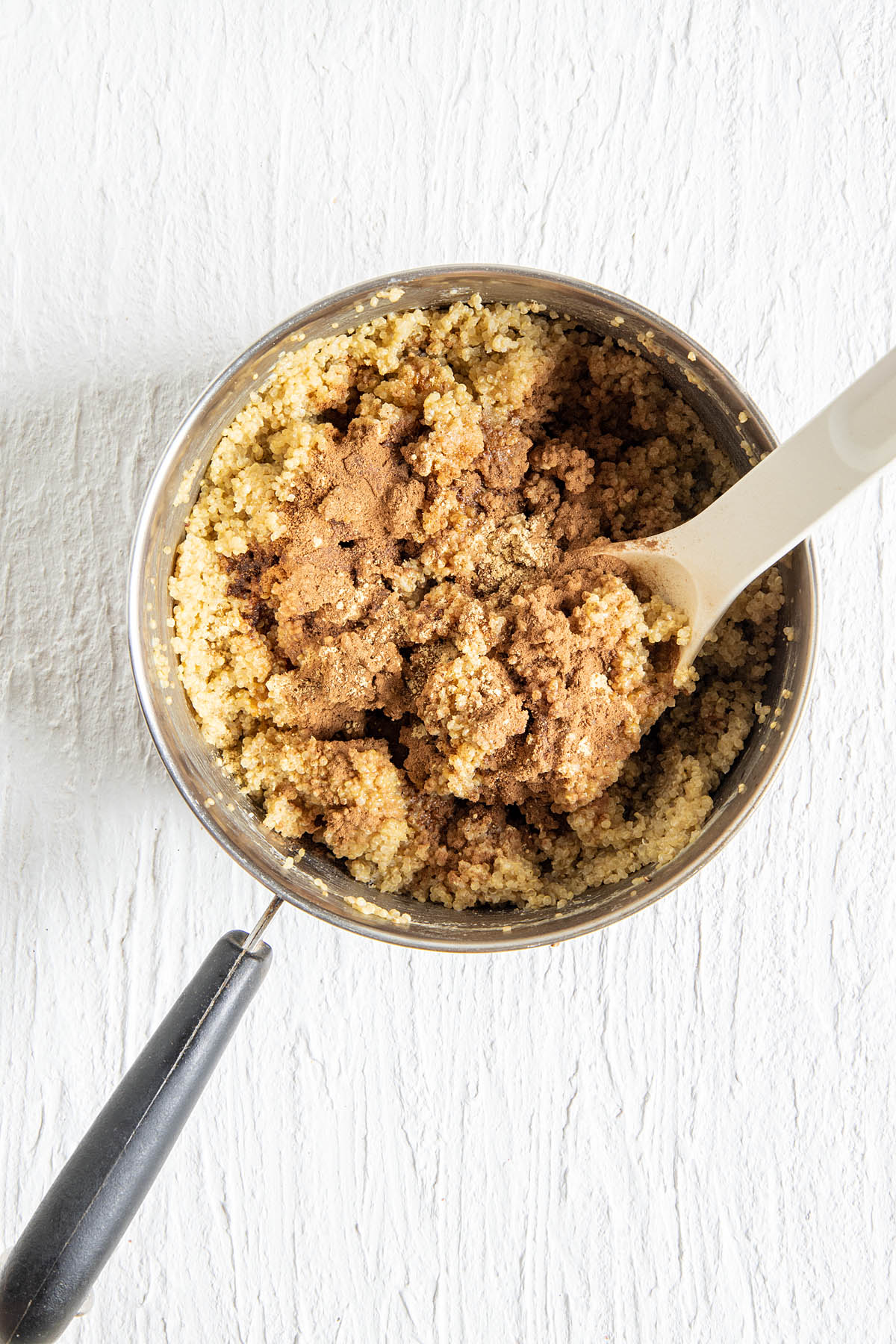Quinoa with maple syrup and spices in a pan.