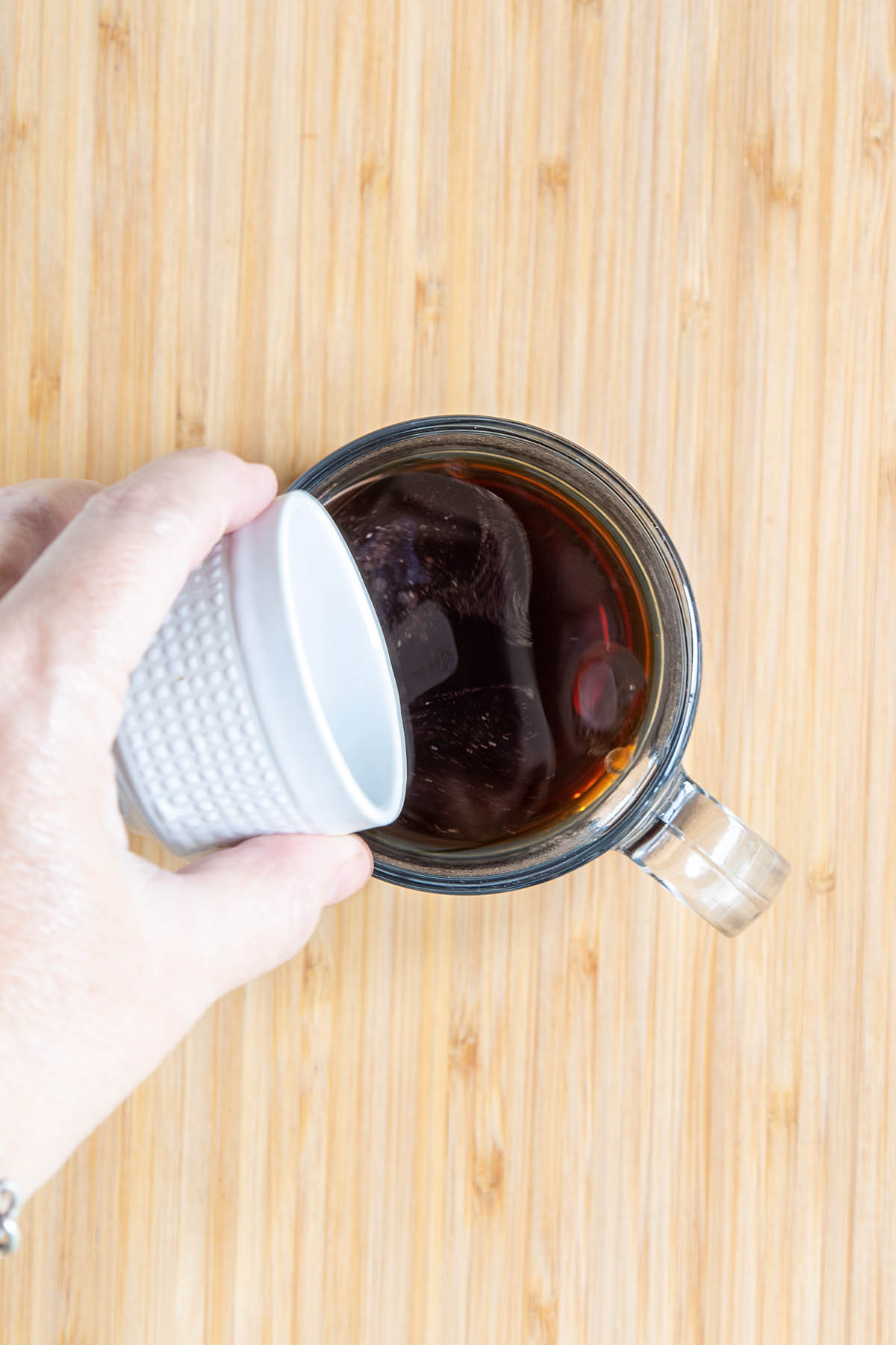 Coconut oil being added to coffee.