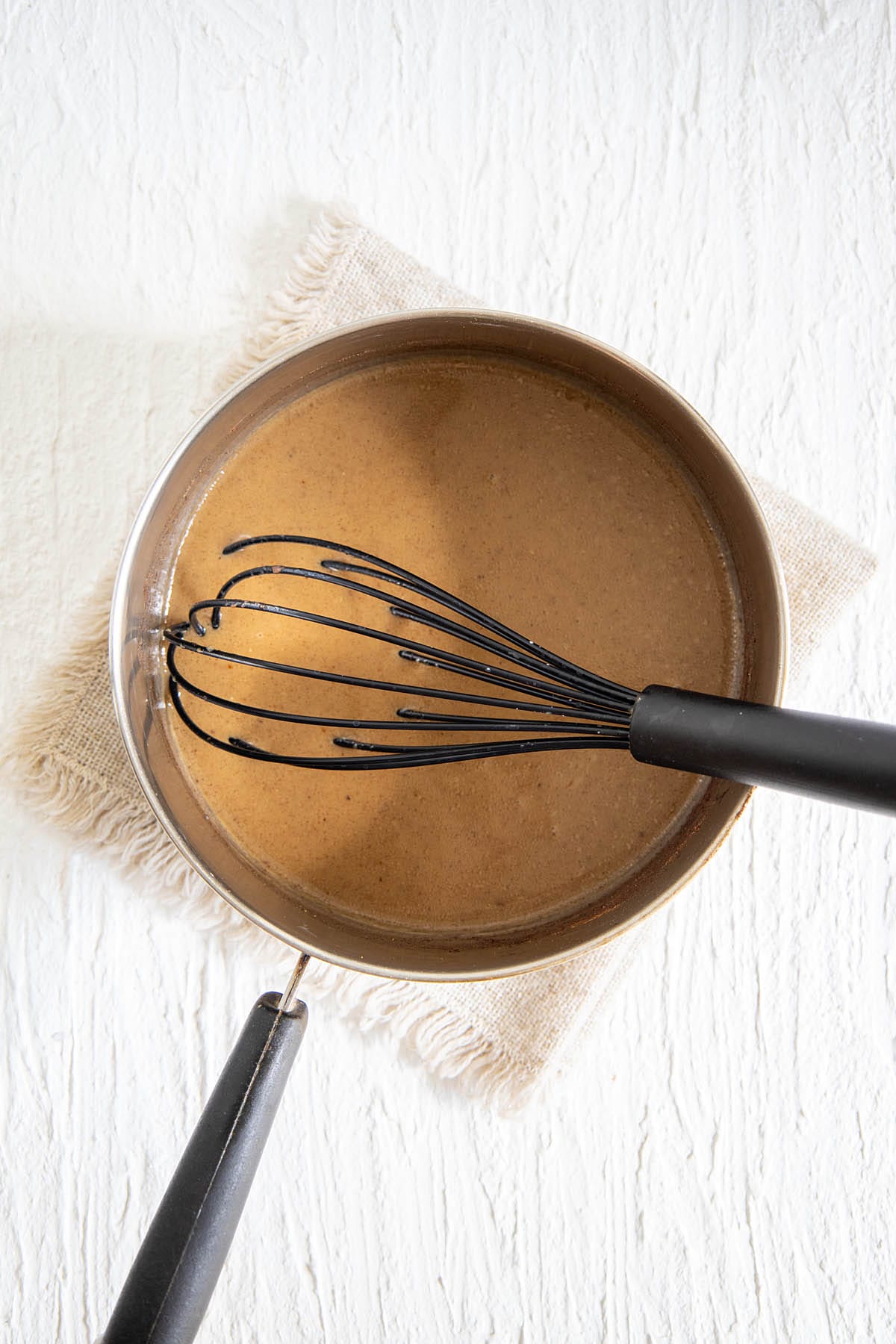 Ingredients in a saucepan with a whisk after heating and whisking.