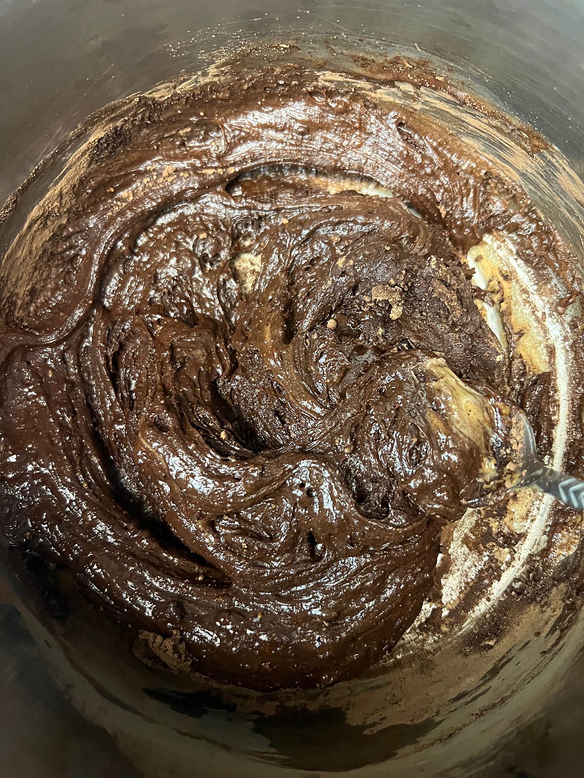 Chocolate peanut butter mixture in a saucepan after heating and mixing.