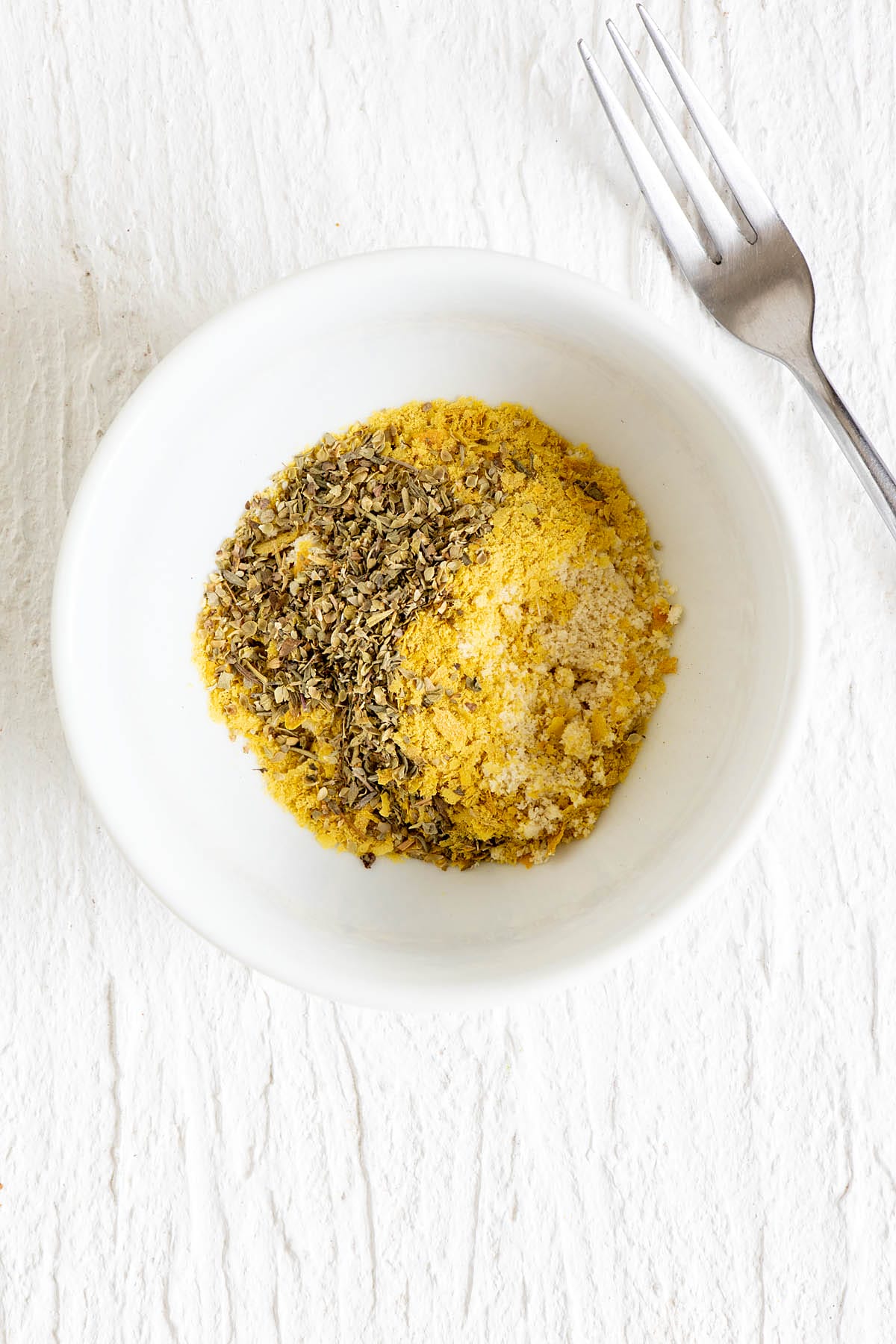 Almond flour, nutritional yeast, and spices in a small bowl.