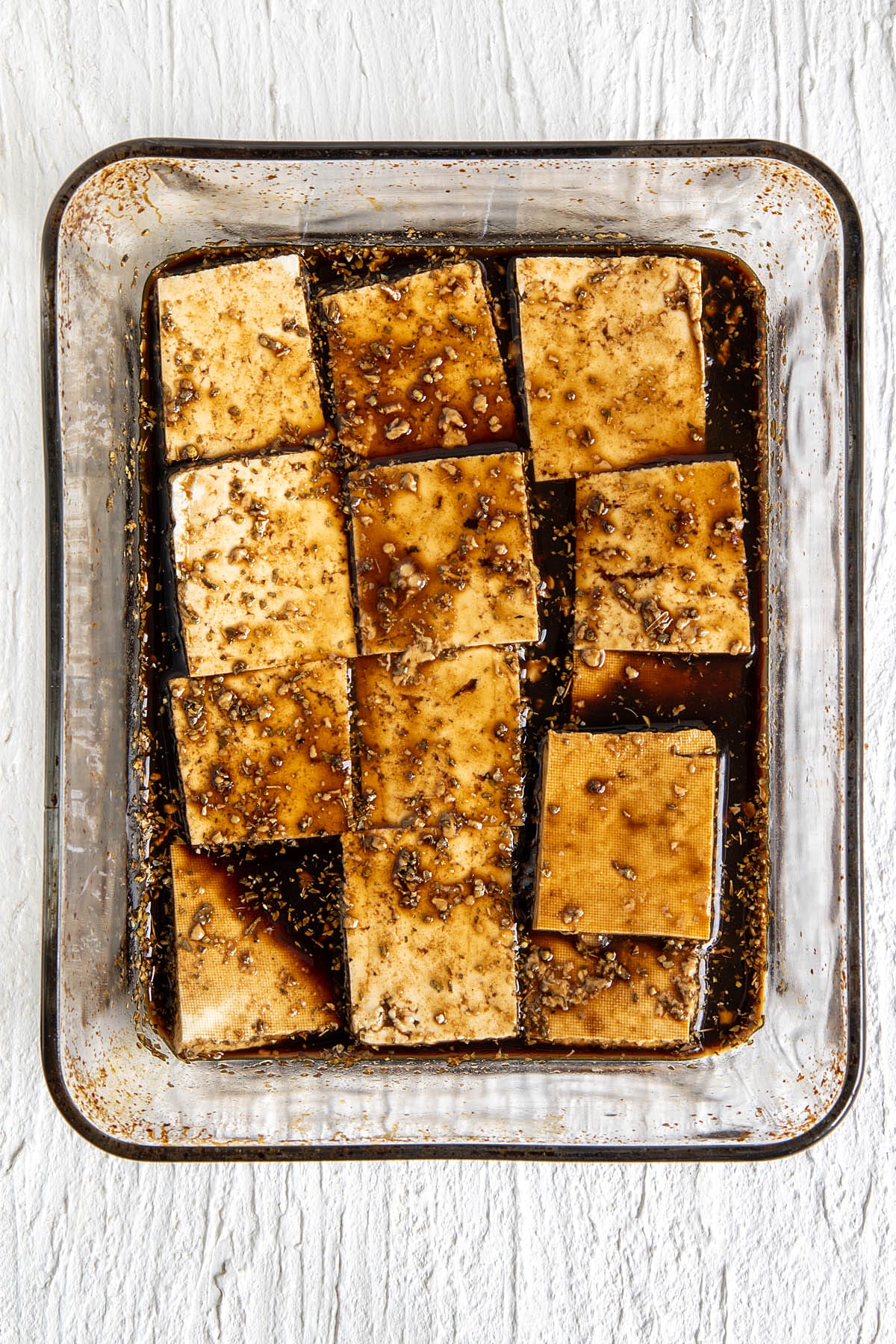 Tofu pieces in a large shallow baking dish.