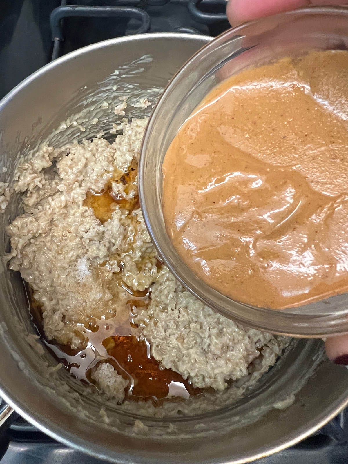 Peanut butter being added to steel cut oat recipe with the rest of the ingredients.