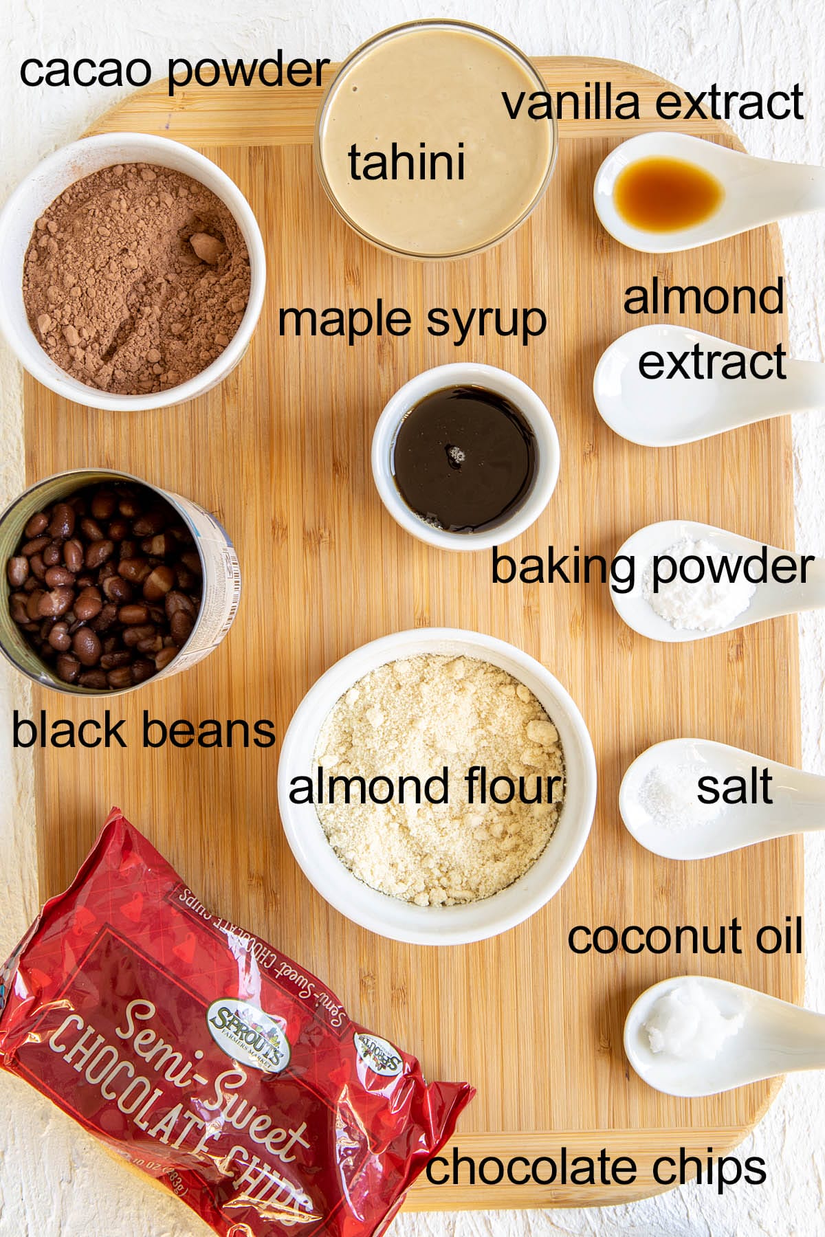 Ingredients for black bean brownies on a cutting board with labels.