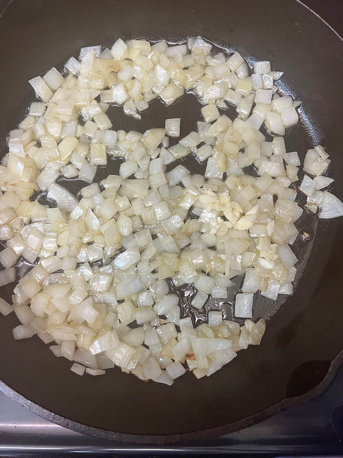 Minced garlic added to the skillet with onions.