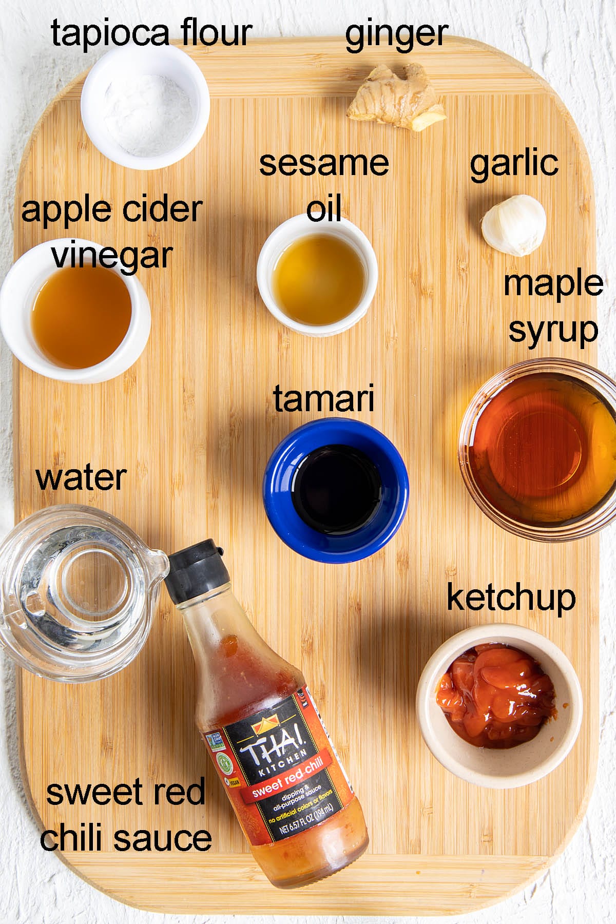 Ingredients for sweet and spicy glaze on a cutting board with labels.