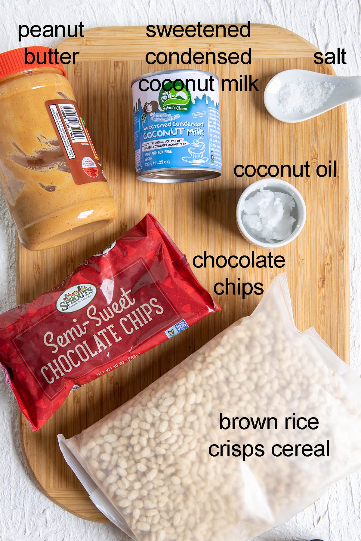 Ingredients for chocolate peanut butter bars on a cutting board with labels.