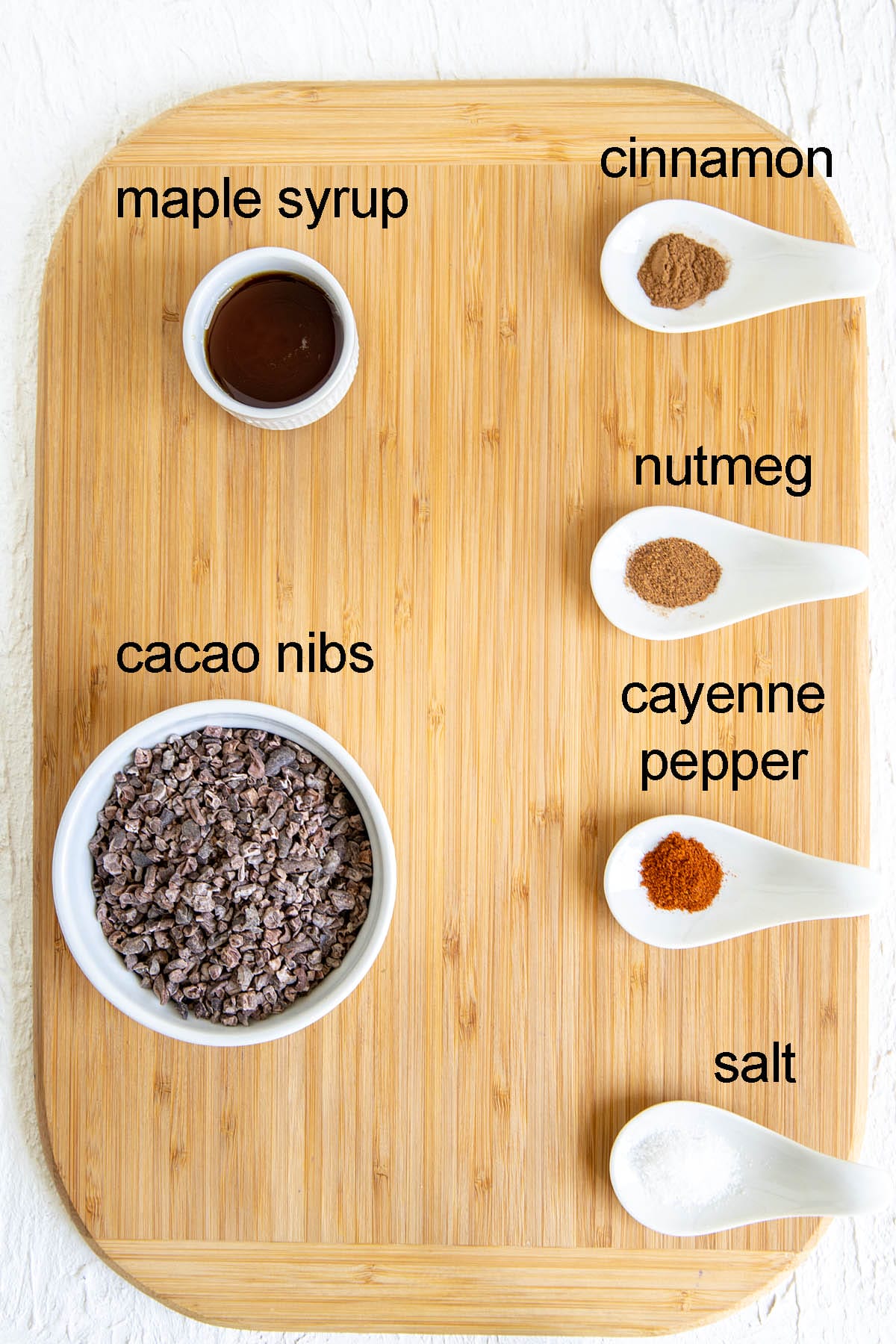 Ingredients for candied cacao nibs on a cutting board with labels.