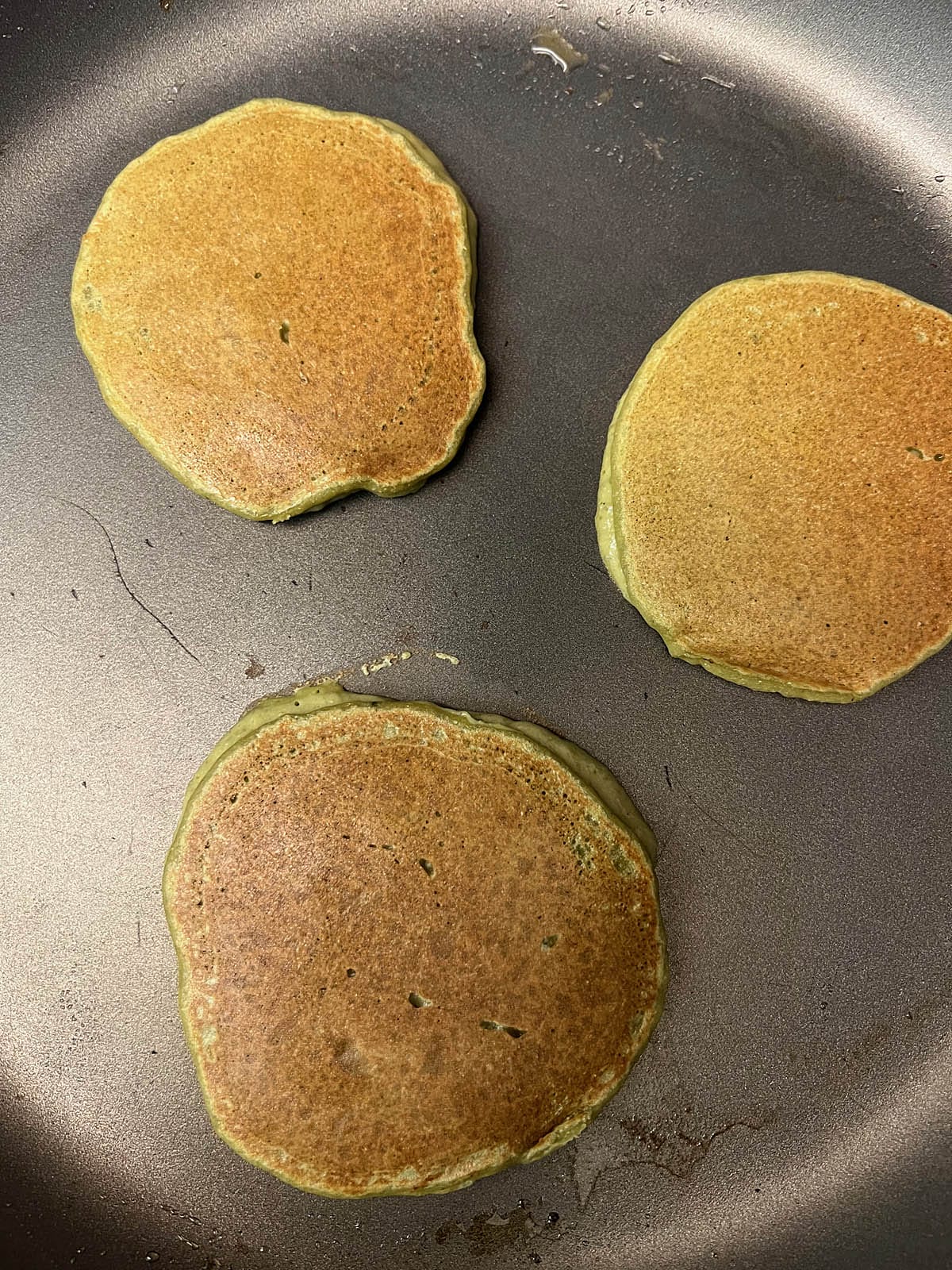 Cooked pancakes on pan.
