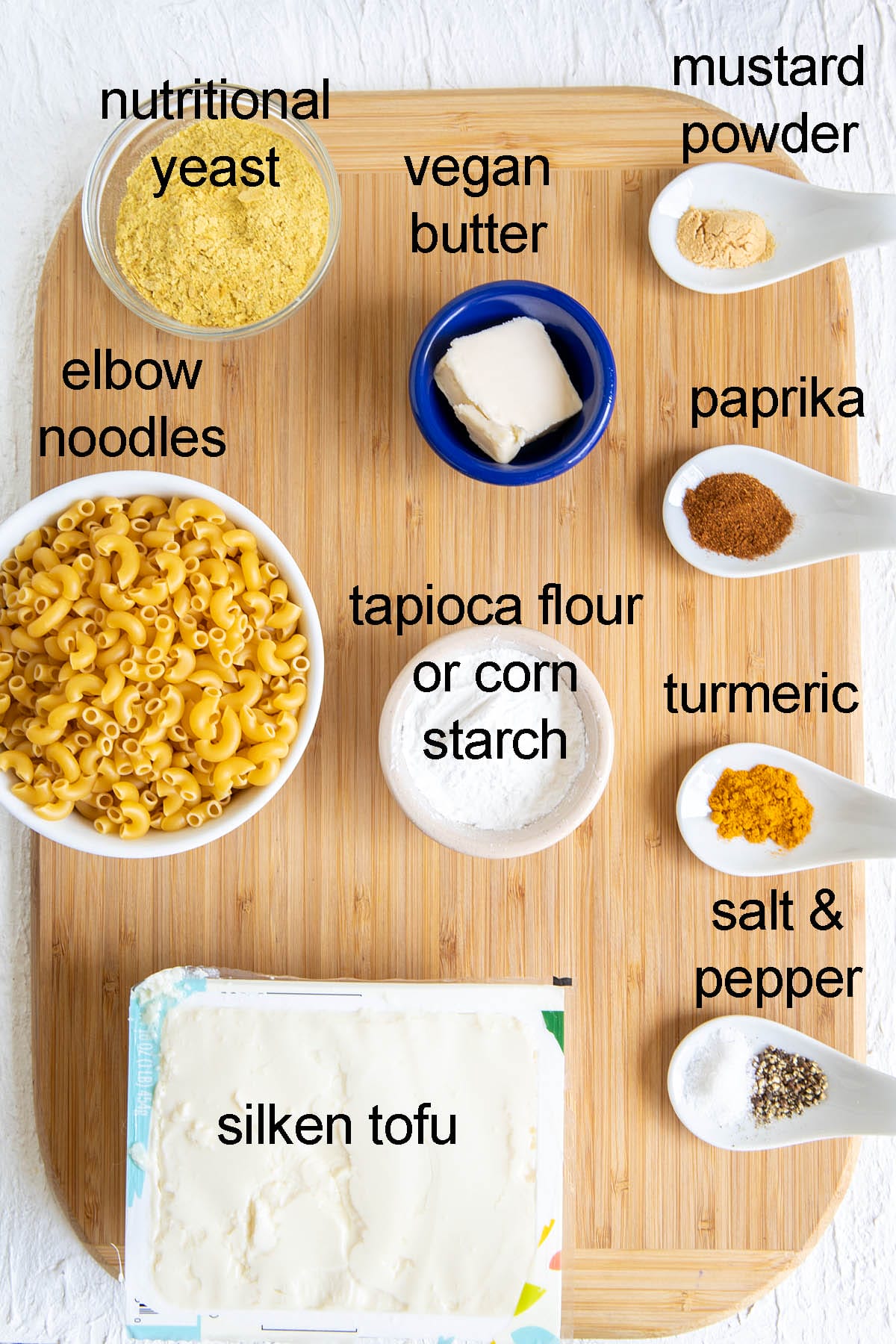 Tofu Mac and cheese ingredients on a cutting board with labels.