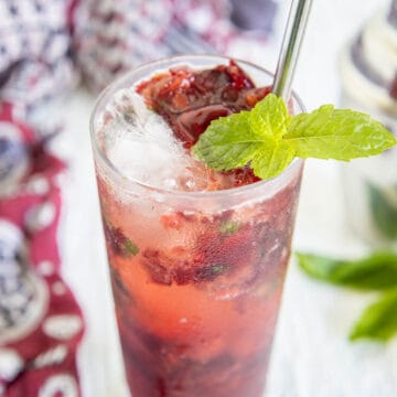 Cherry Mojito in a tall glass with straw.