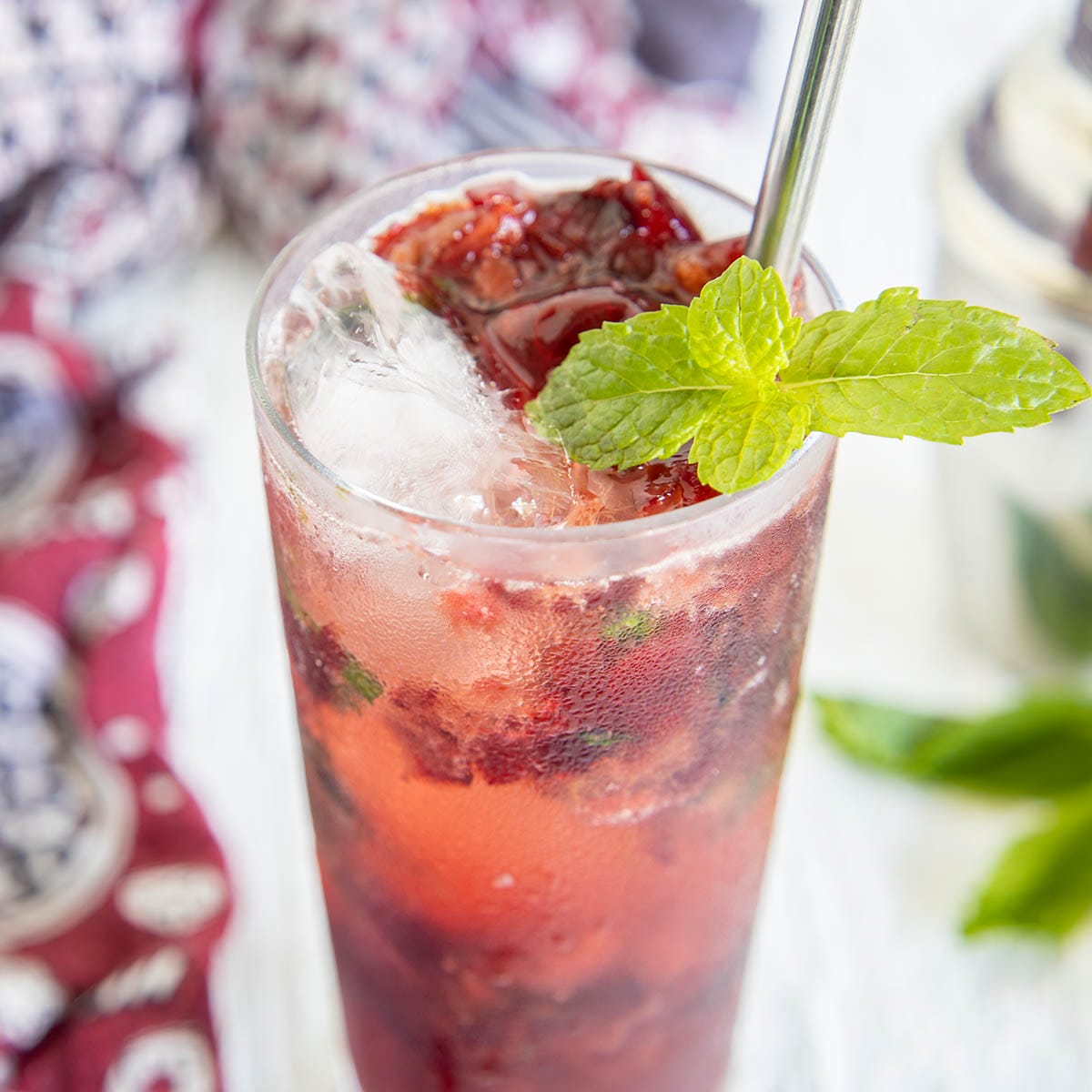 Cherry Mojito in a tall glass with straw.