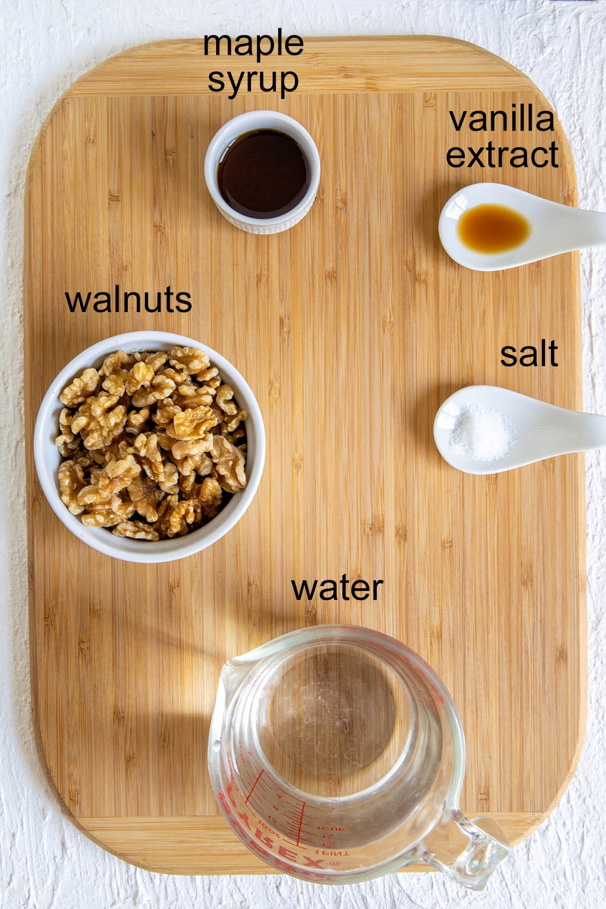 Homemade Walnut Milk ingredients on a cutting board with labels.