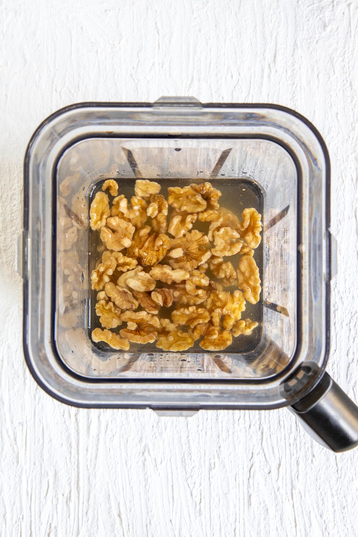 Walnuts, water, maple syrup, vanilla extract, and salt in a blender.
