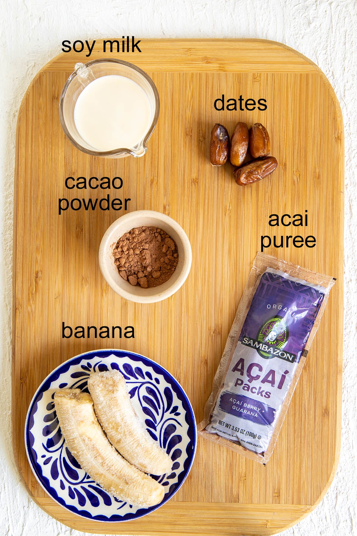 Chocolate Acai Bowl ingredients on a cutting board with labels.