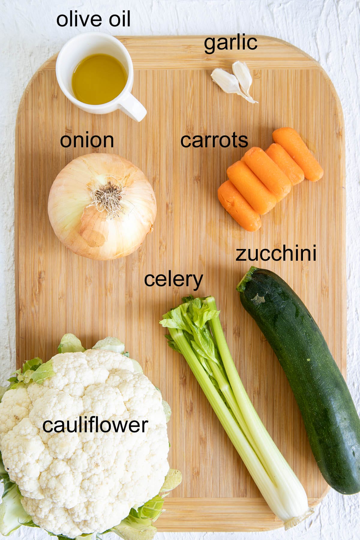 Garden Vegetable Soup ingredients on a cutting board with labels.