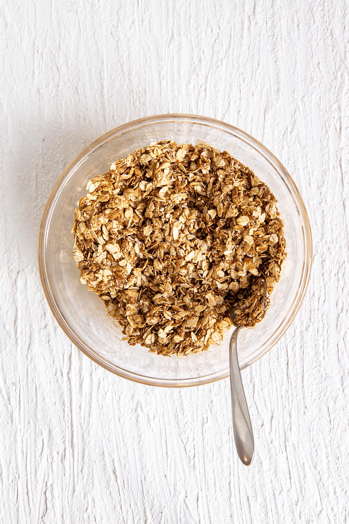 Rolled oats and wet ingredients in a mixing bowl.