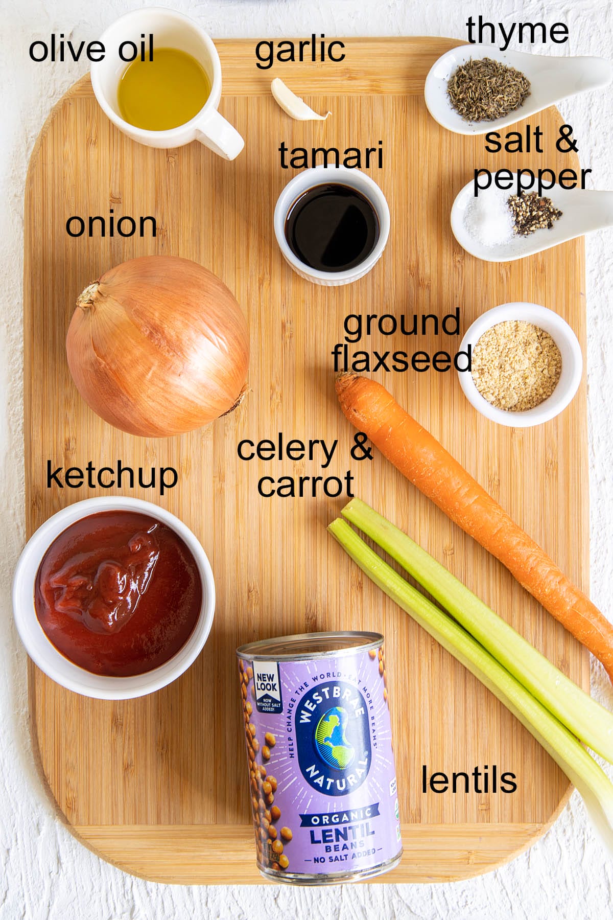 Lentil loaf ingredients on a cutting board with labels.