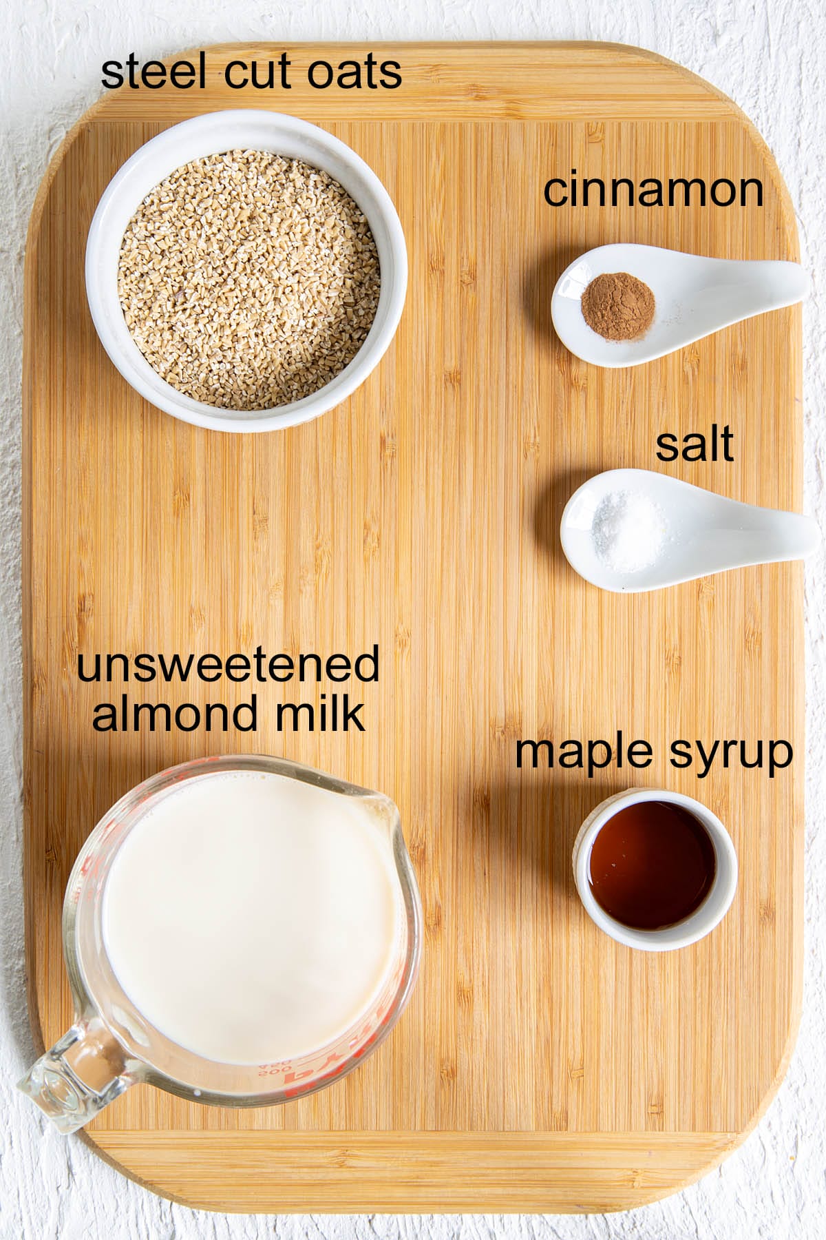 Maple Cinnamon Steel Cut Oats ingredients on a cutting board with labels.