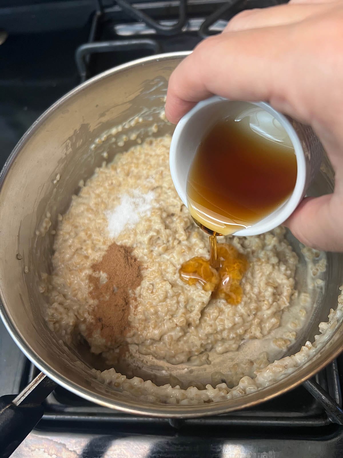 Cinnamon, salt, and maple syrup added to the pan.